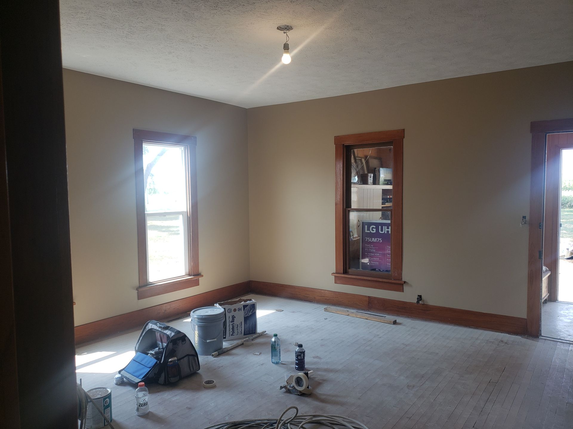 An empty room with a lot of paint on the floor