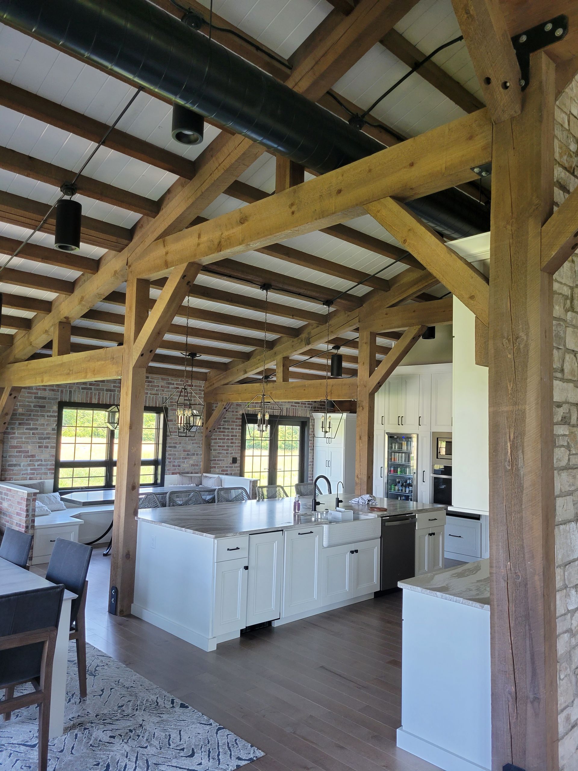 A kitchen with wooden beams and white cabinets