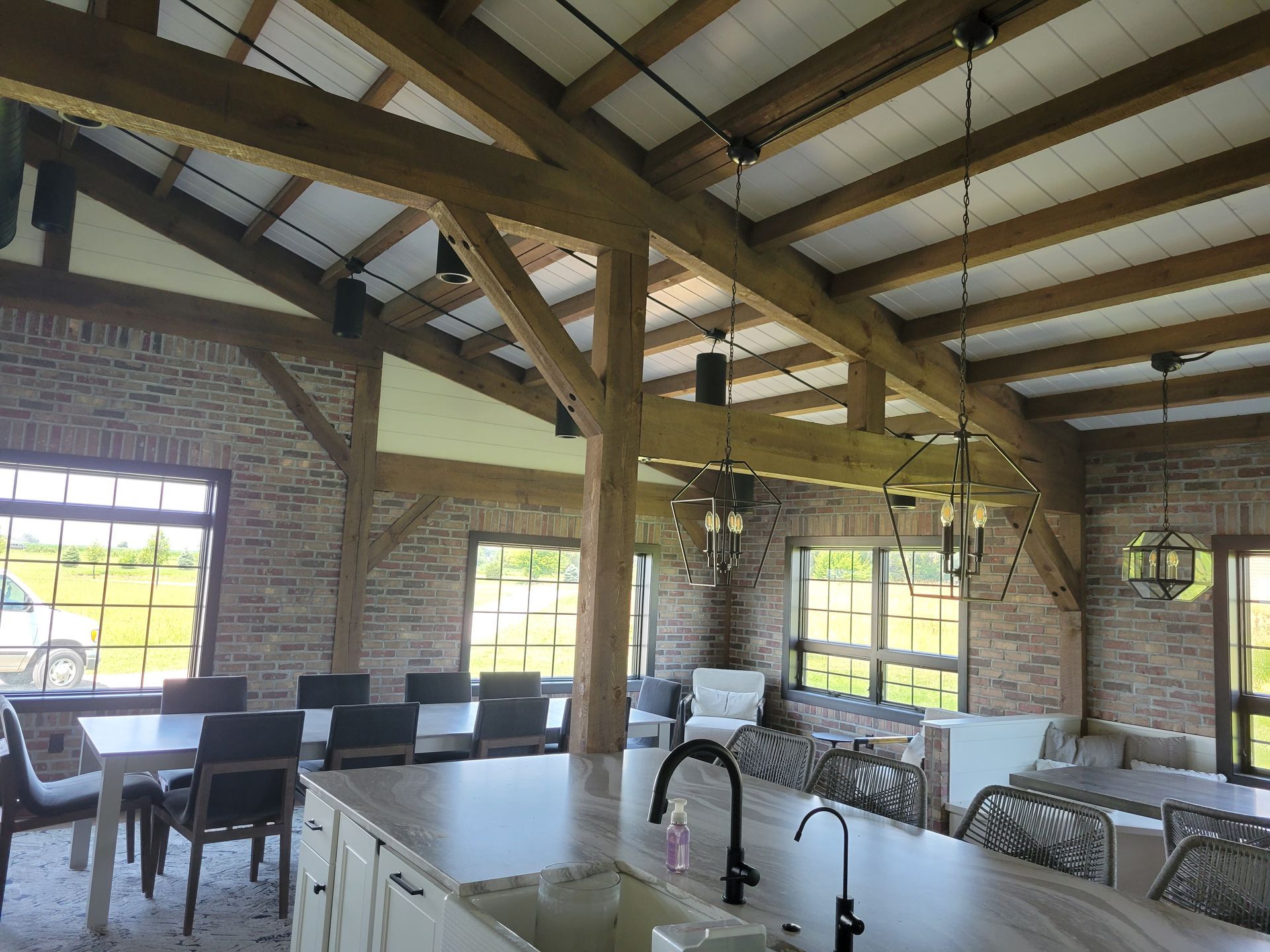 A kitchen with a sink and a dining room in the background