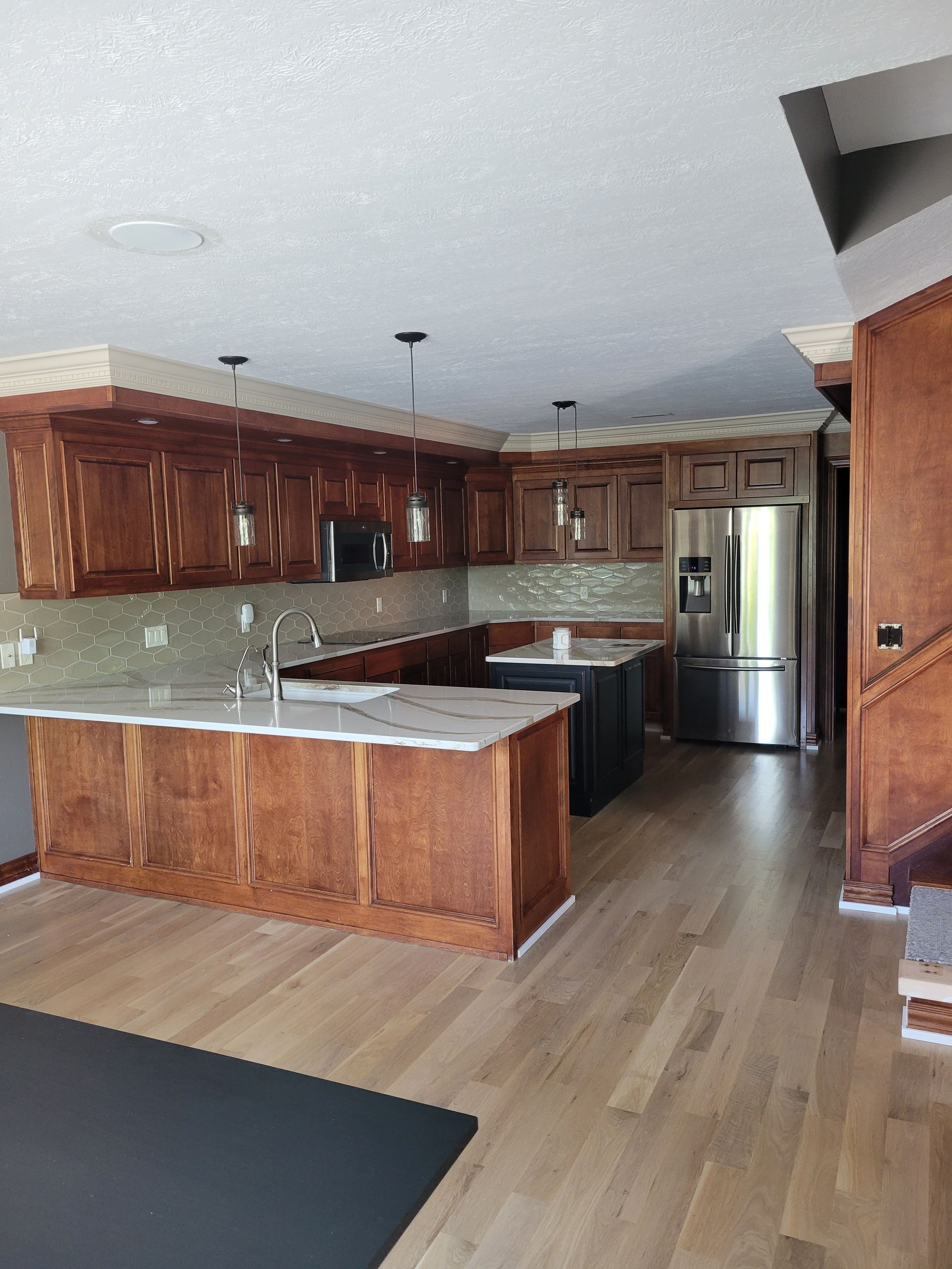 A kitchen with stainless steel appliances and wooden cabinets