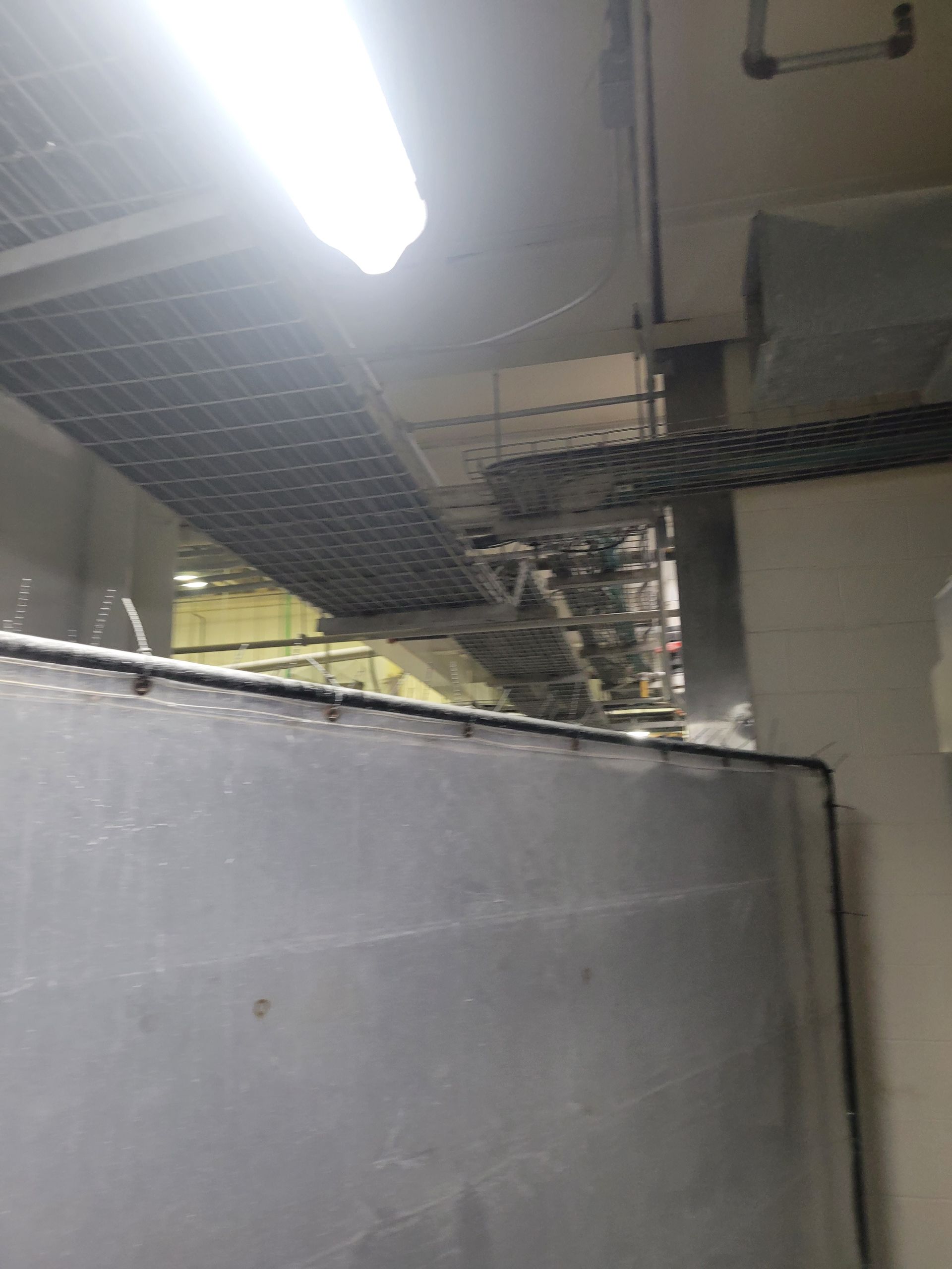 A room with a ceiling that has a lot of wires hanging from it.