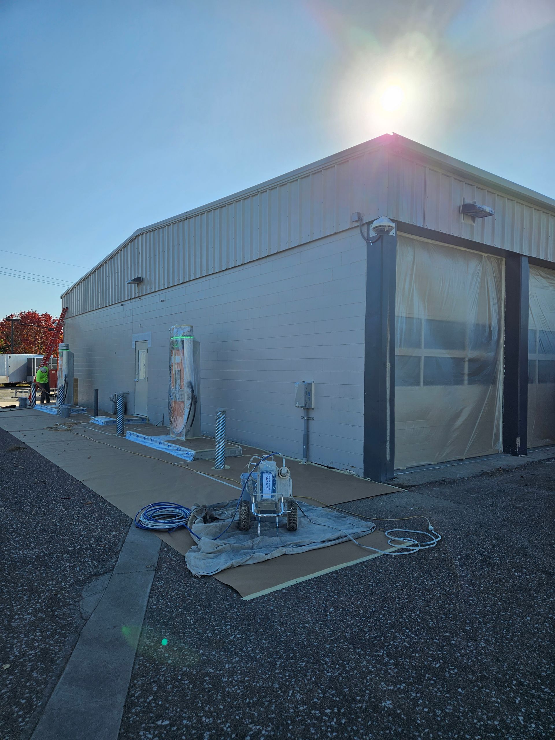 A large building with a lot of windows is being painted.