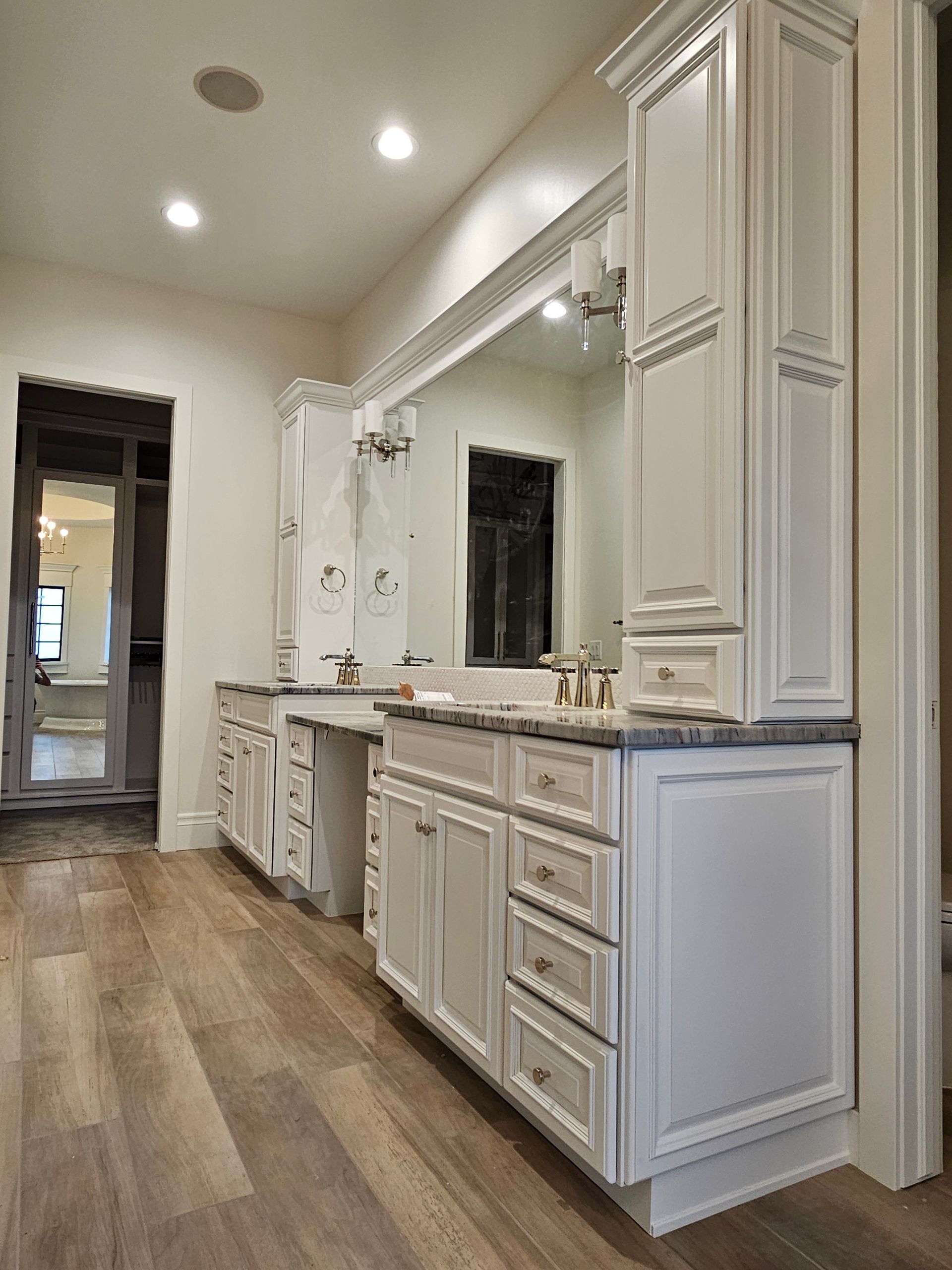 A bathroom with two sinks and a large mirror.