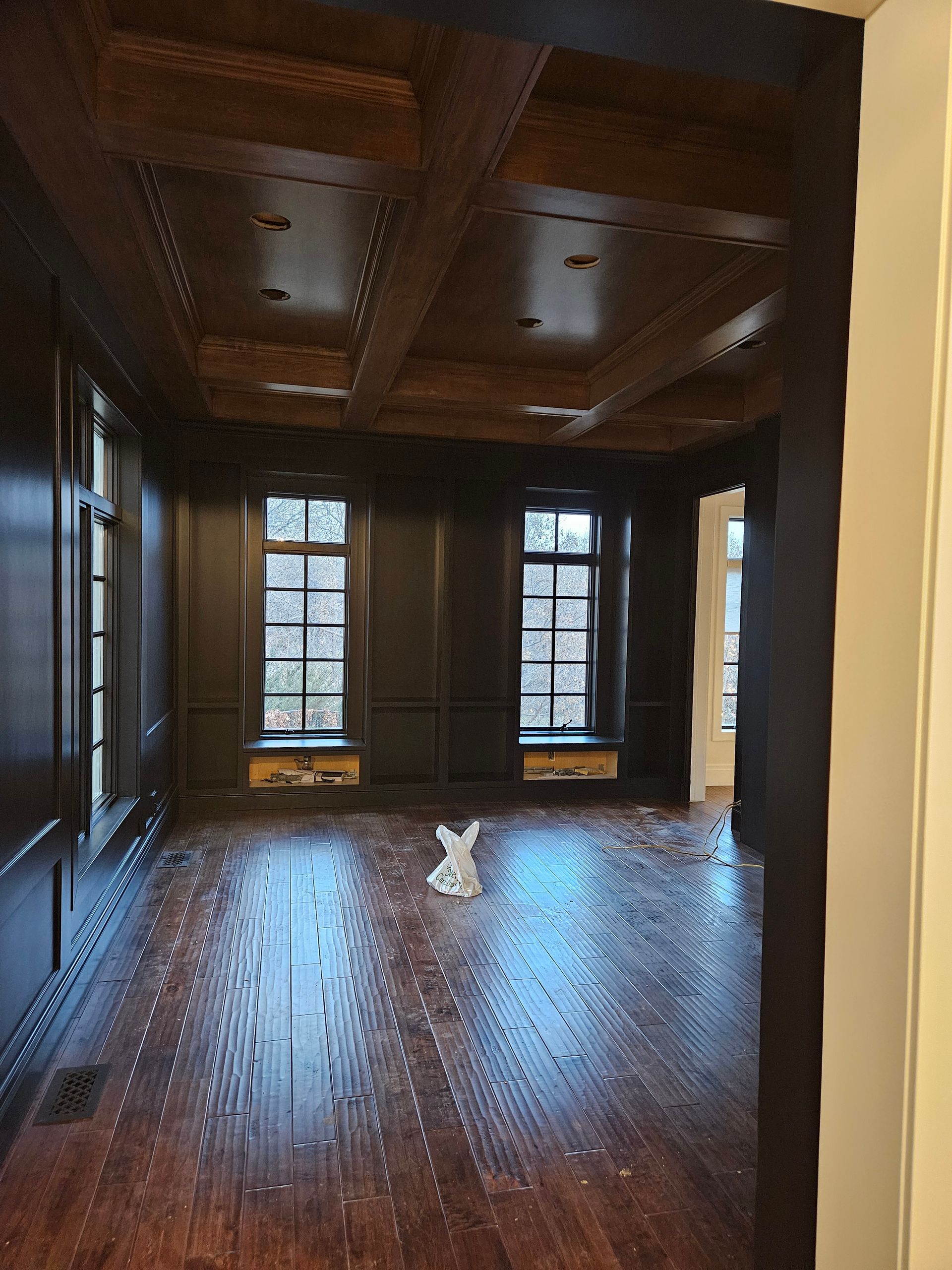 An empty room with wooden floors and a ceiling