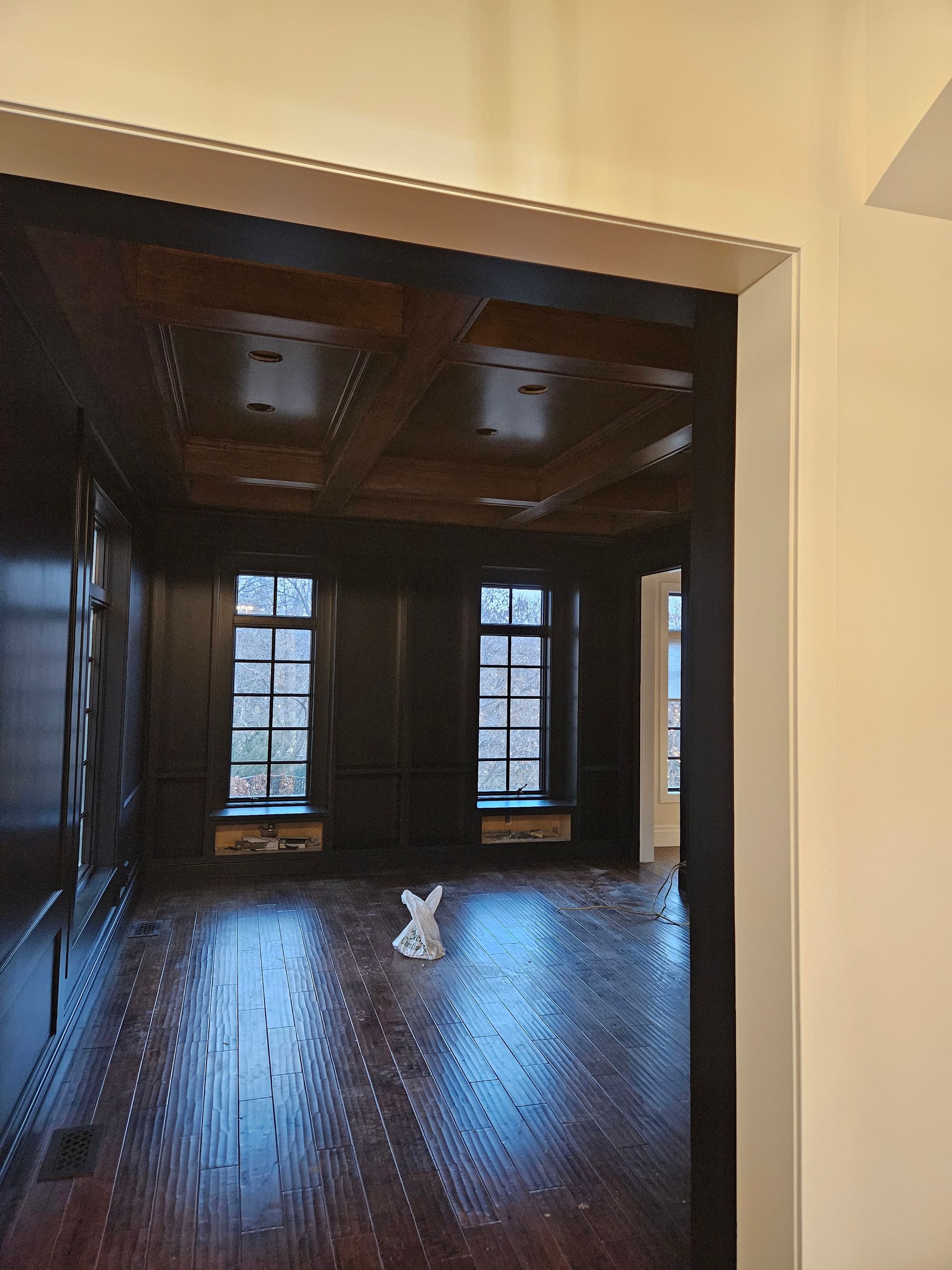 An empty room with a bunny statue on the floor