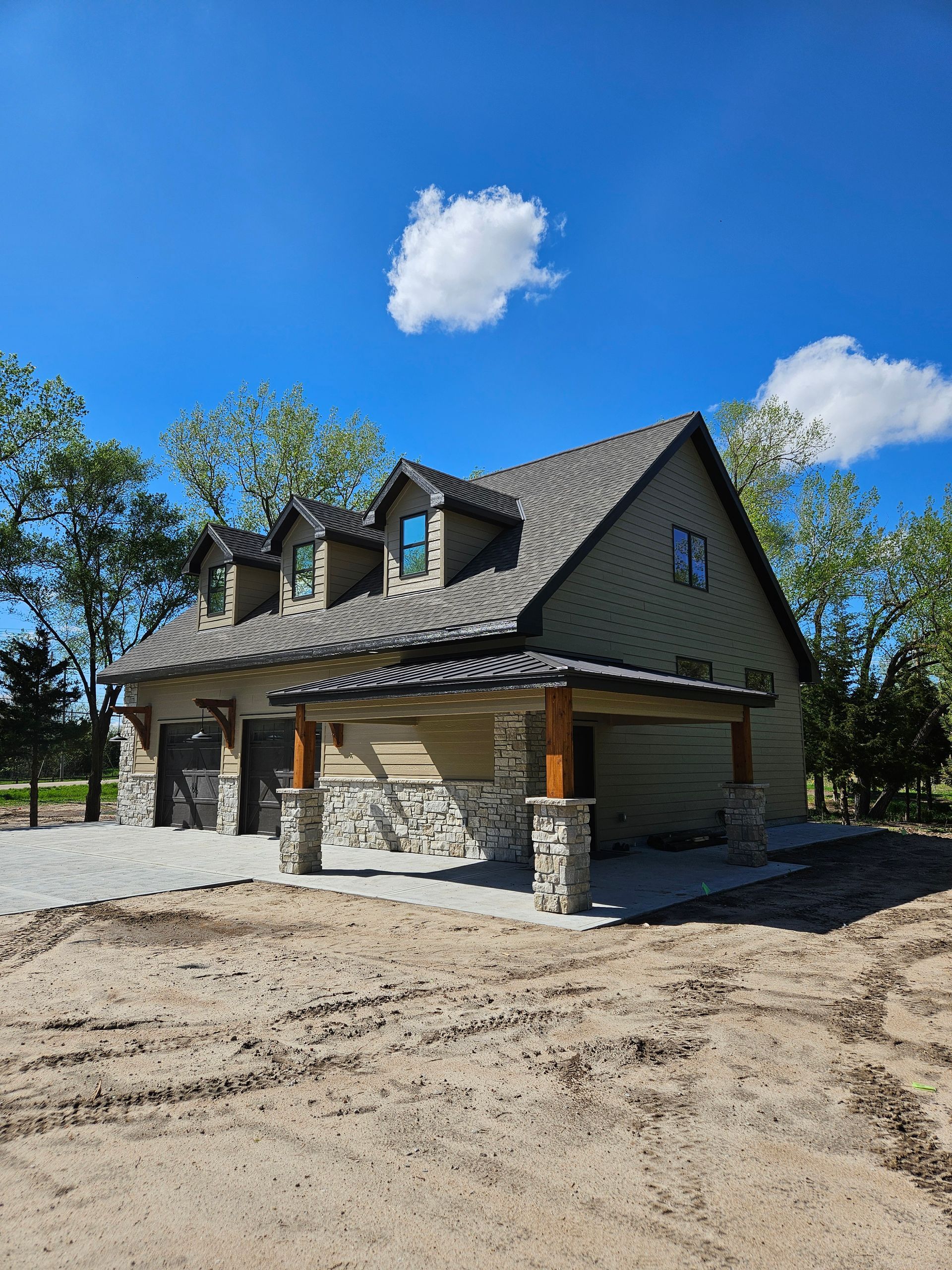 A house is being built in the middle of a dirt field.