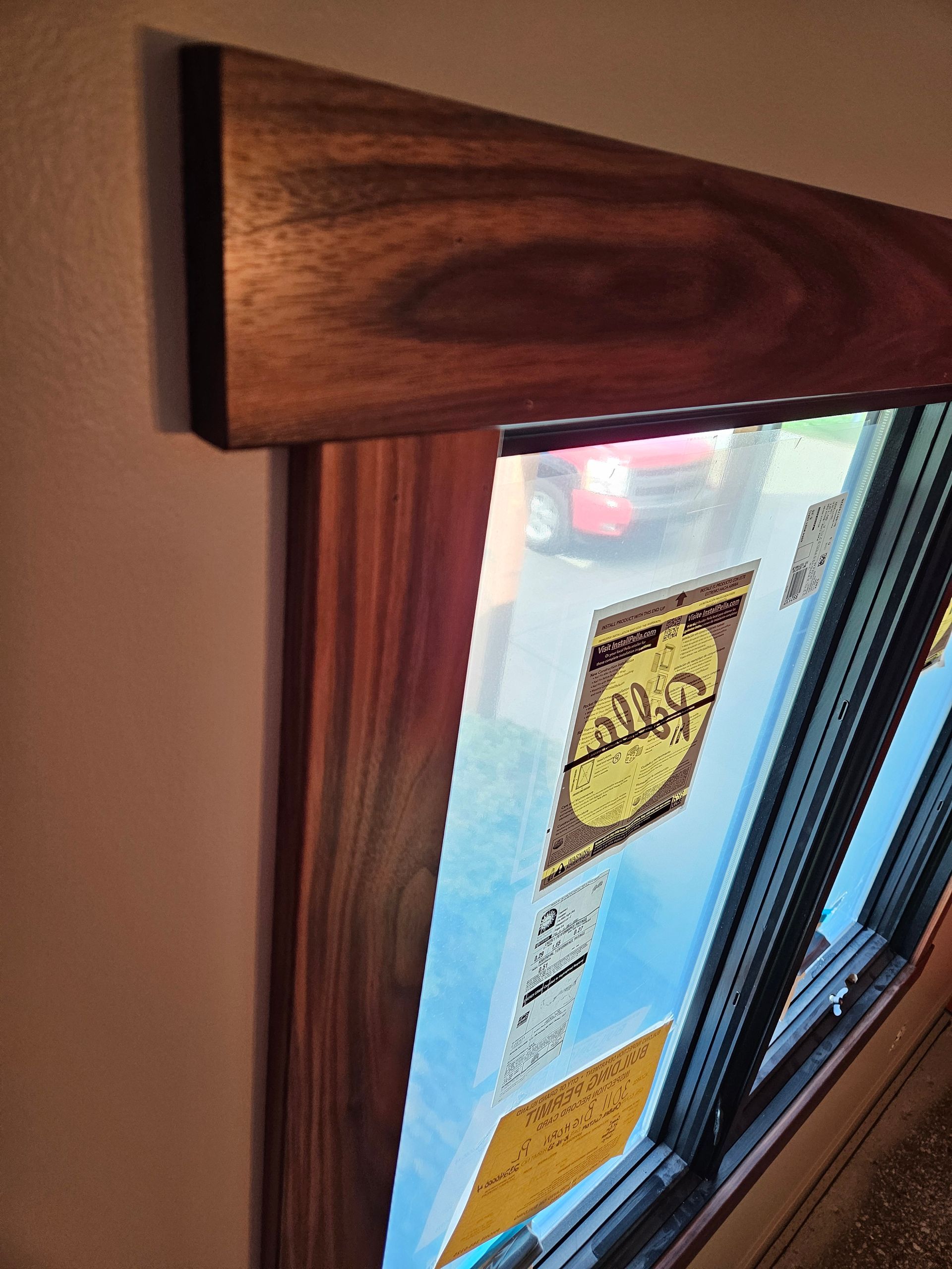 A close up of a window with a wooden frame