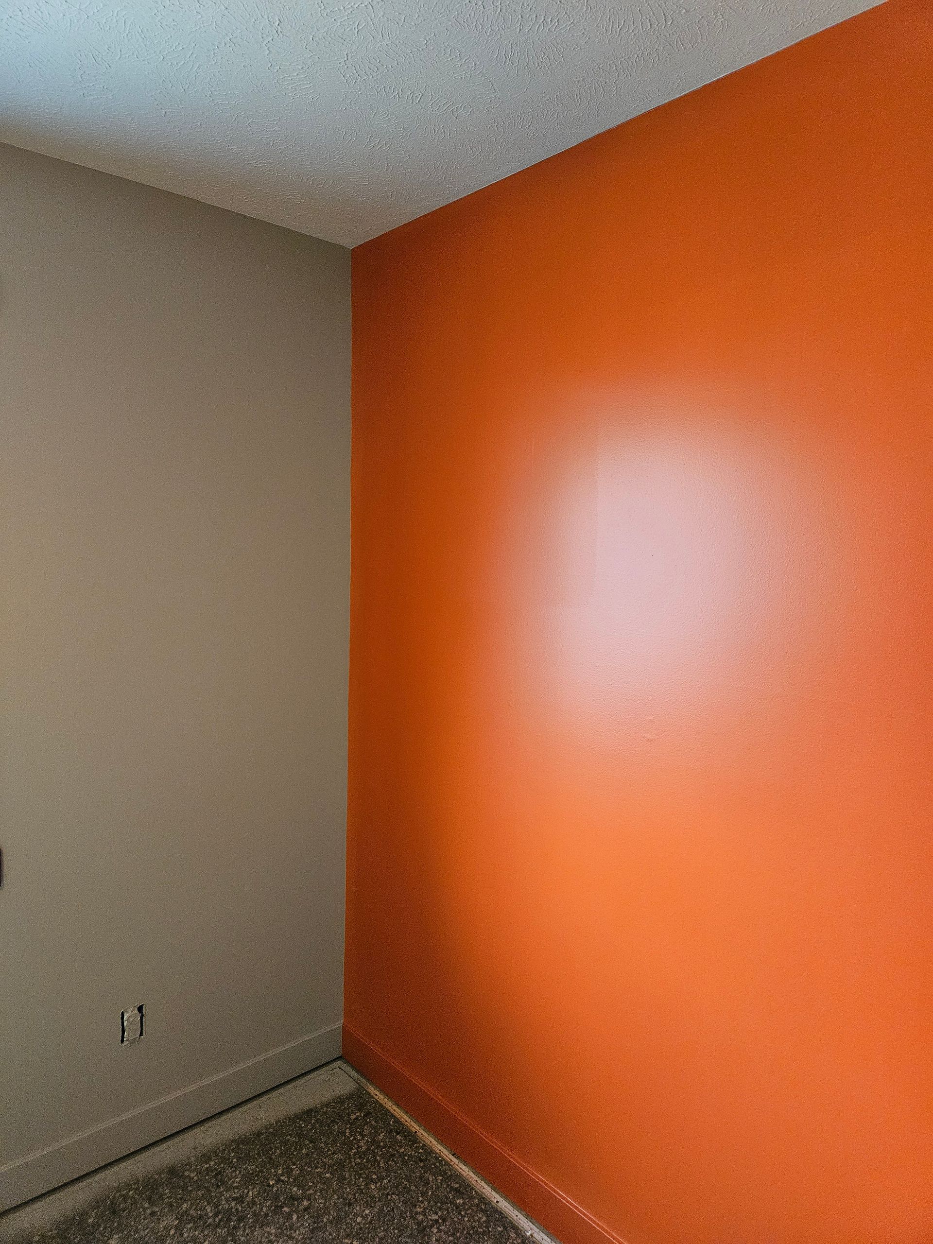 A room with orange walls and a white ceiling.