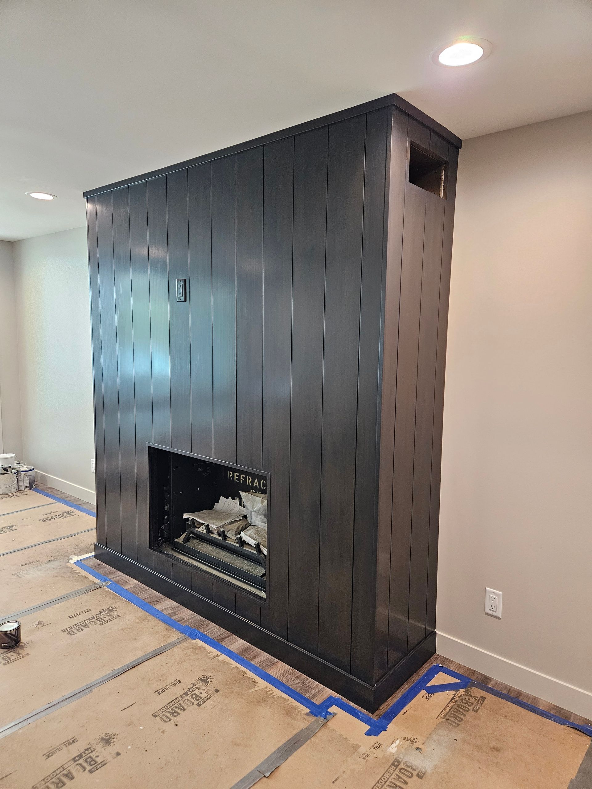 There is a fireplace in the middle of the room.