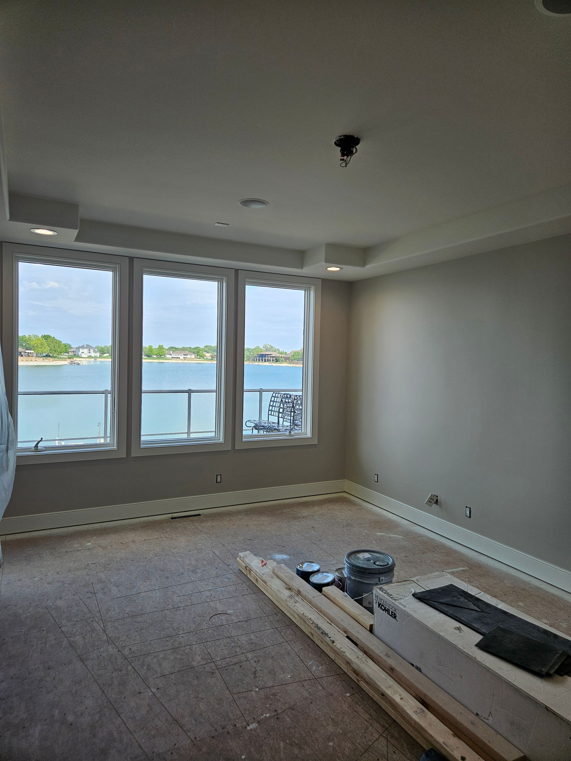 A room with a lot of windows and a view of the water.