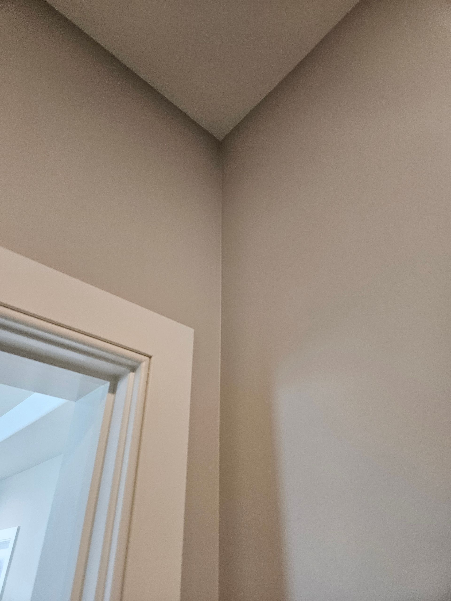 A close up of a door in a room with a ceiling.