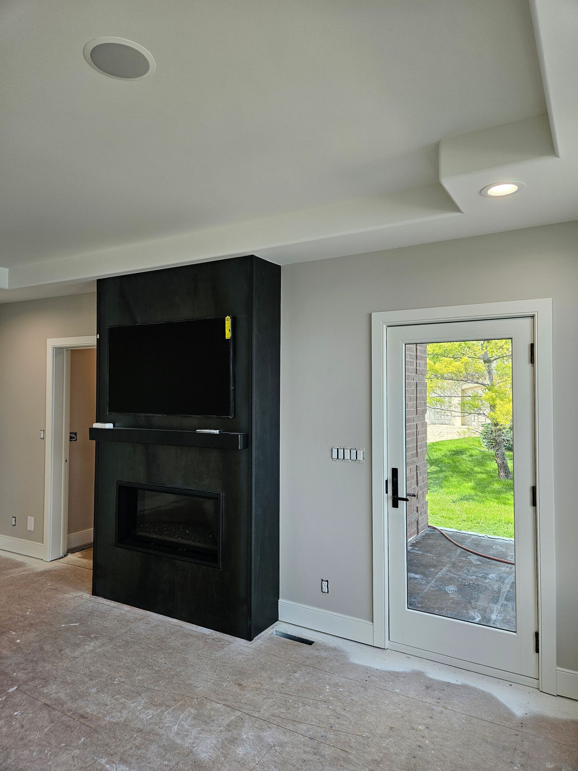 A living room with a fireplace and a flat screen tv