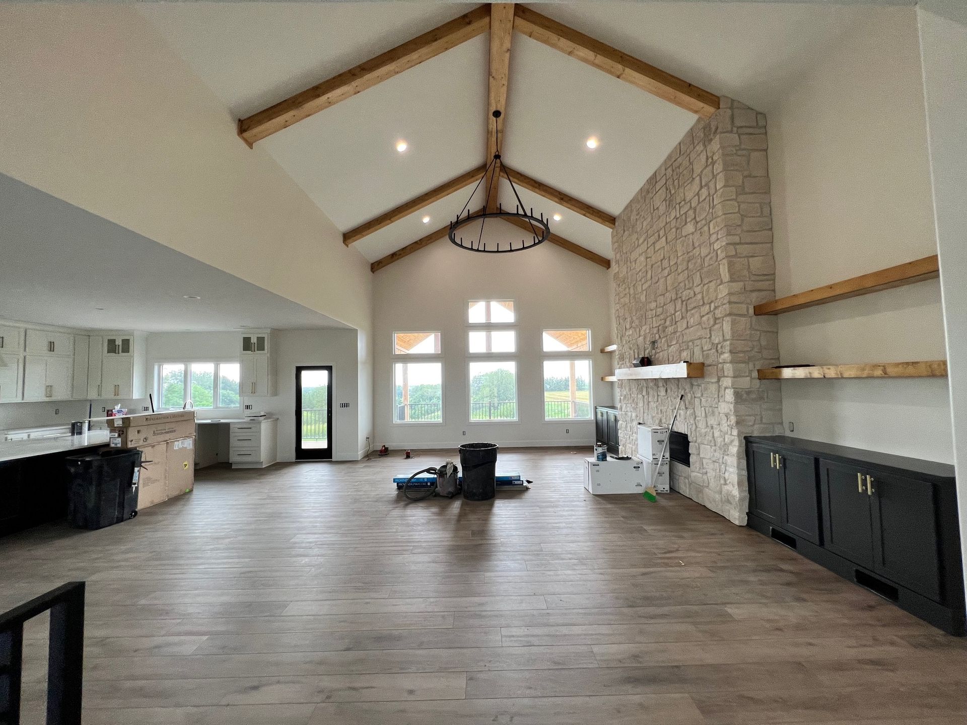 A large empty room with a vaulted ceiling and a fireplace.