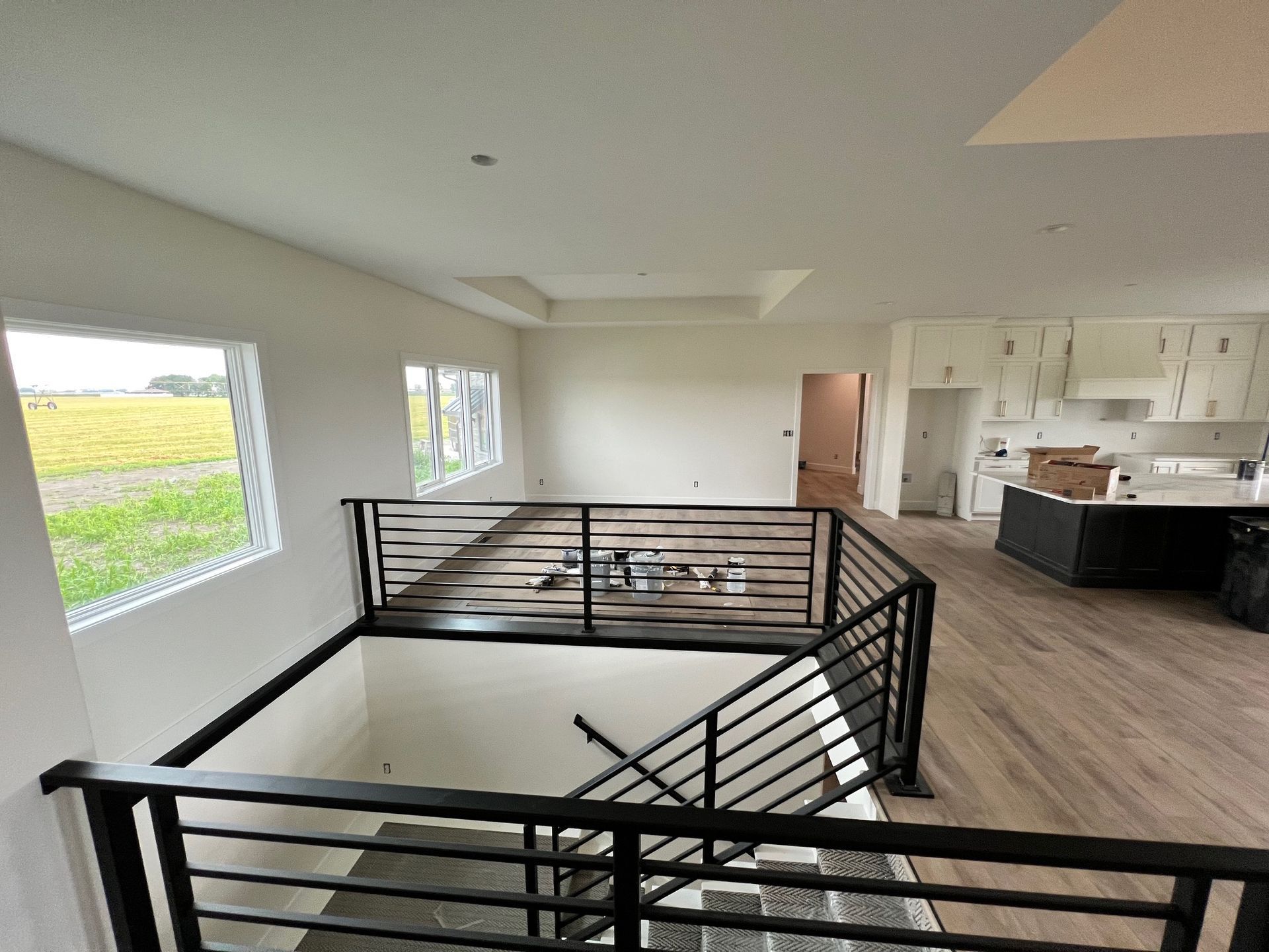 A staircase in a house with a black railing