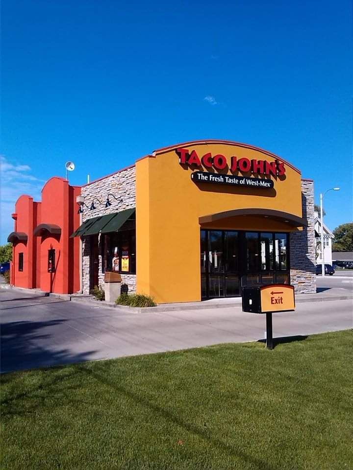 A taco john 's restaurant with a mailbox in front of it