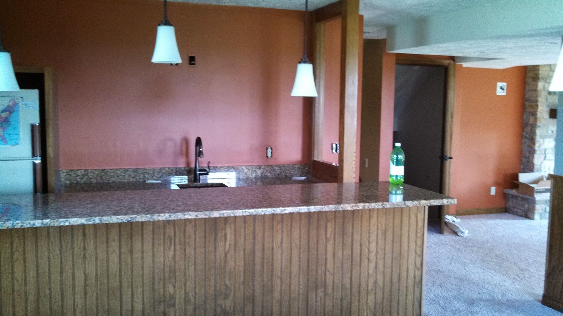 An empty kitchen with a sprite bottle on the counter