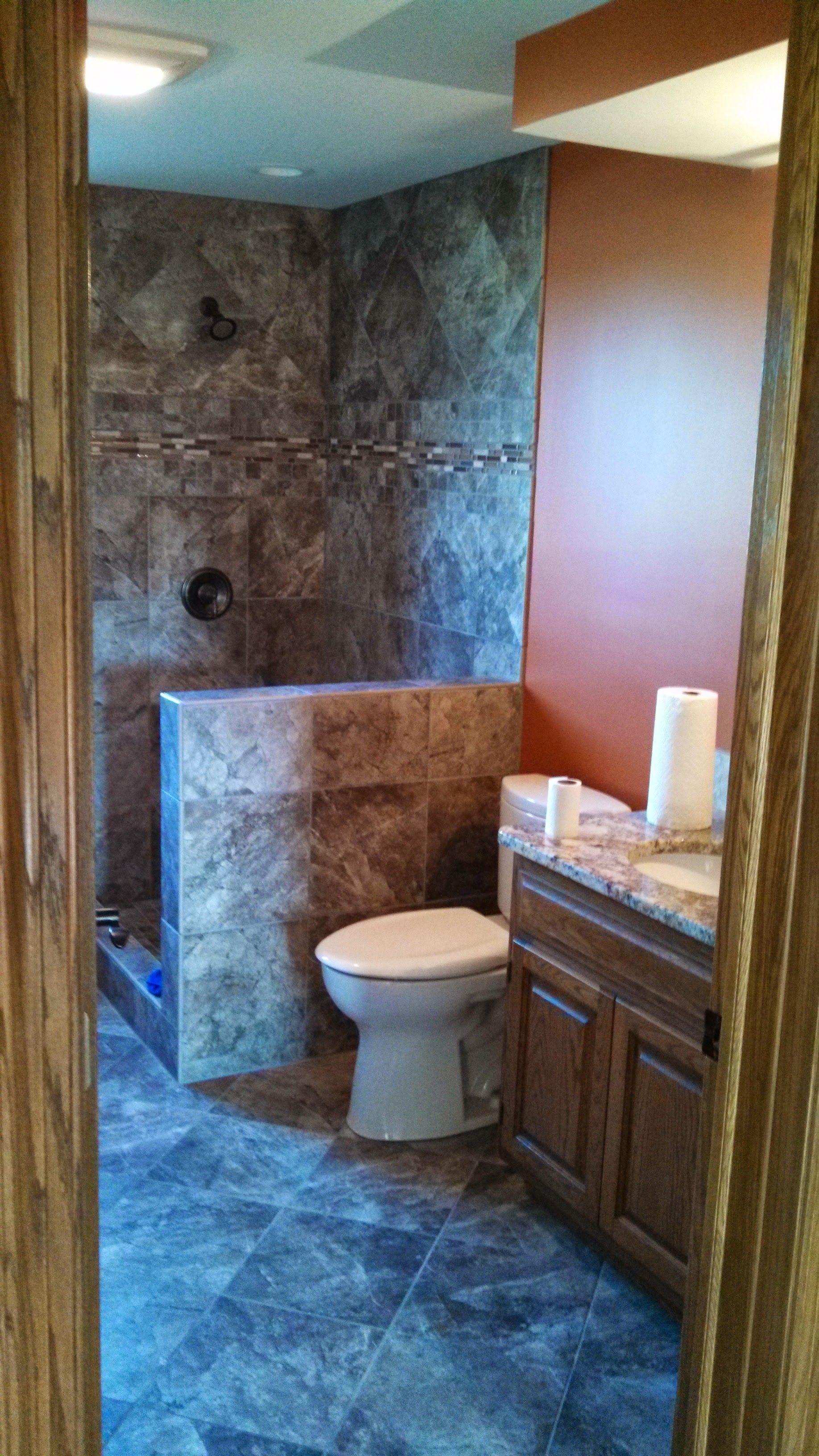 A bathroom with a toilet , sink , and shower.