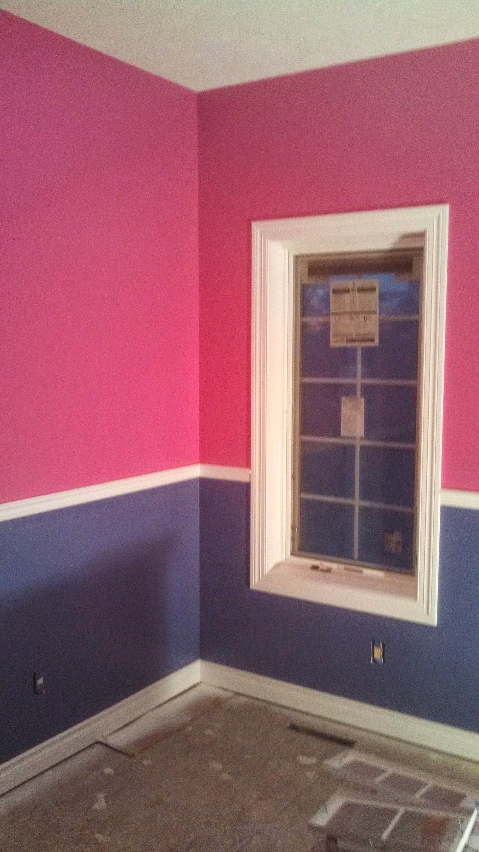 A room with pink and blue walls and a window