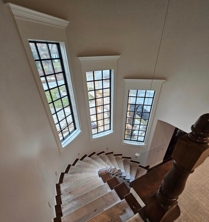 A staircase in a house with a black railing