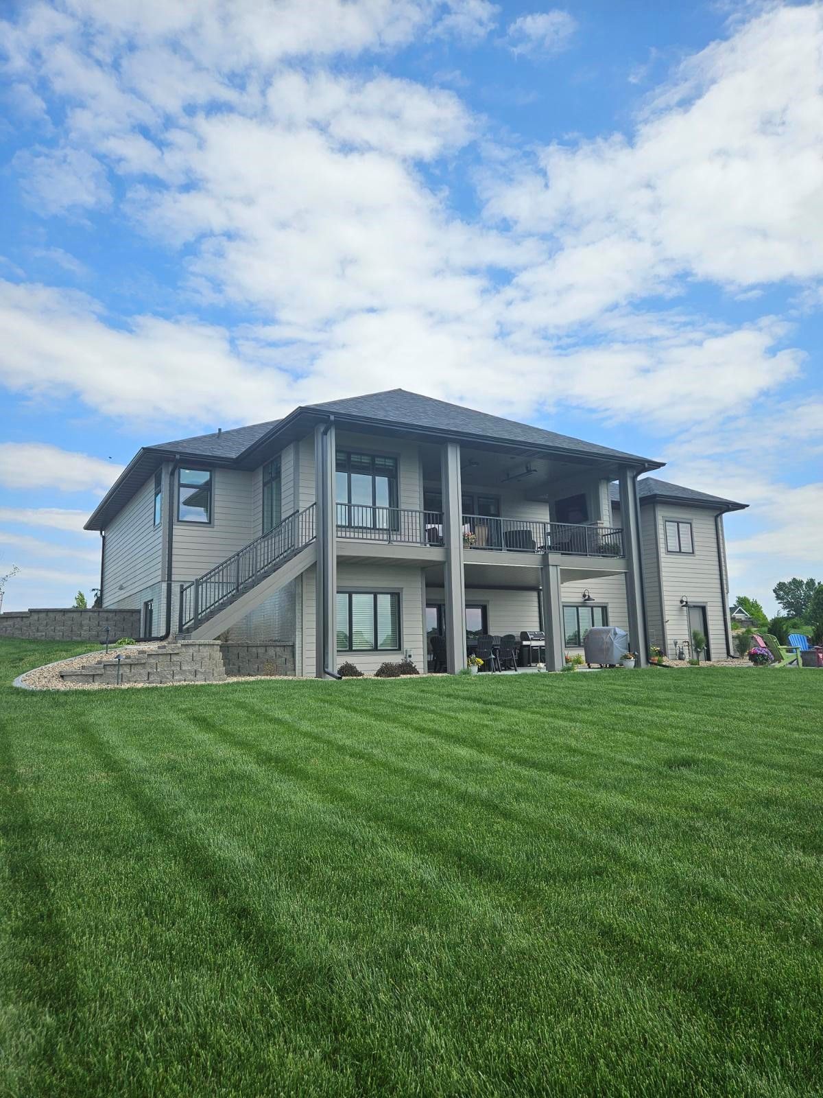 A large house with a lush green lawn in front of it.