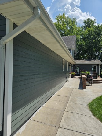 The side of a house with a walkway leading to it.