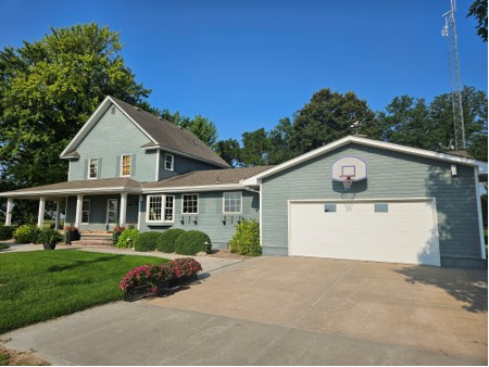 A large house with a basketball hoop in front of it