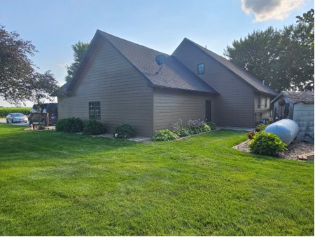 A large house with a large lawn in front of it.