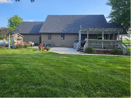 A large house with a large lawn in front of it.