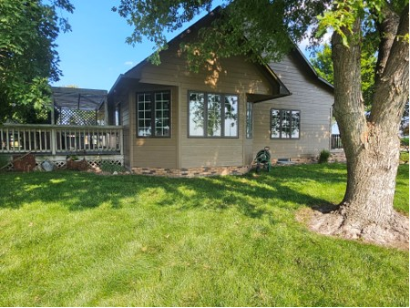 A house with a lot of windows and a tree in front of it