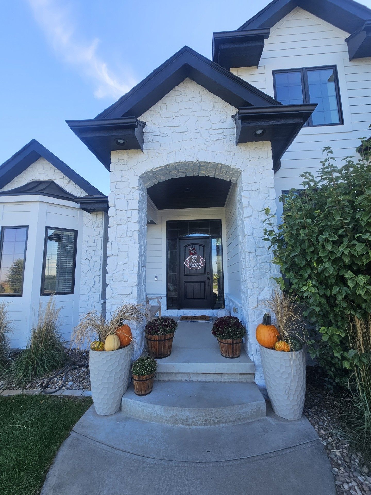A white house with black trim and a black door