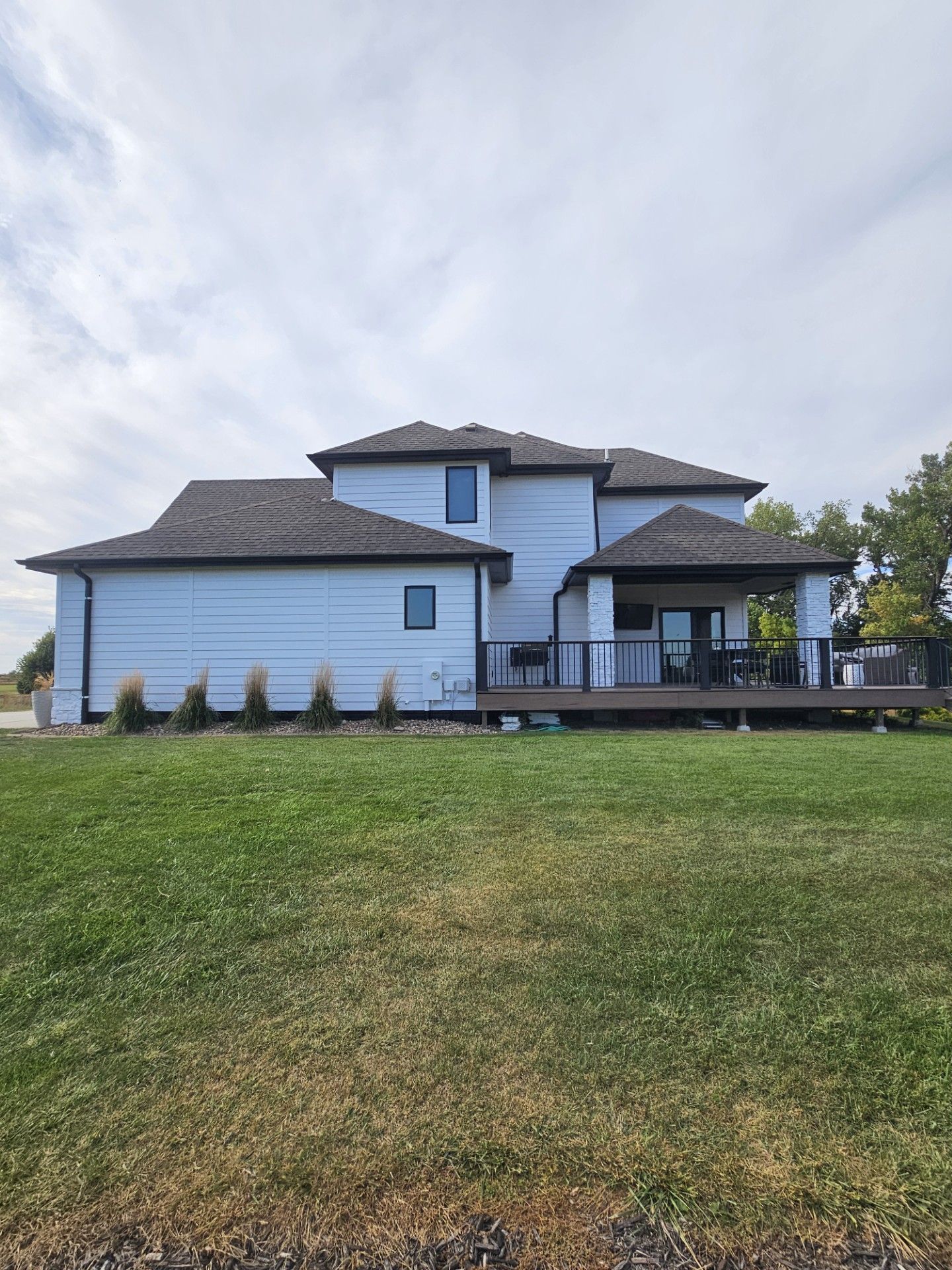 A large white house with a large lawn in front of it