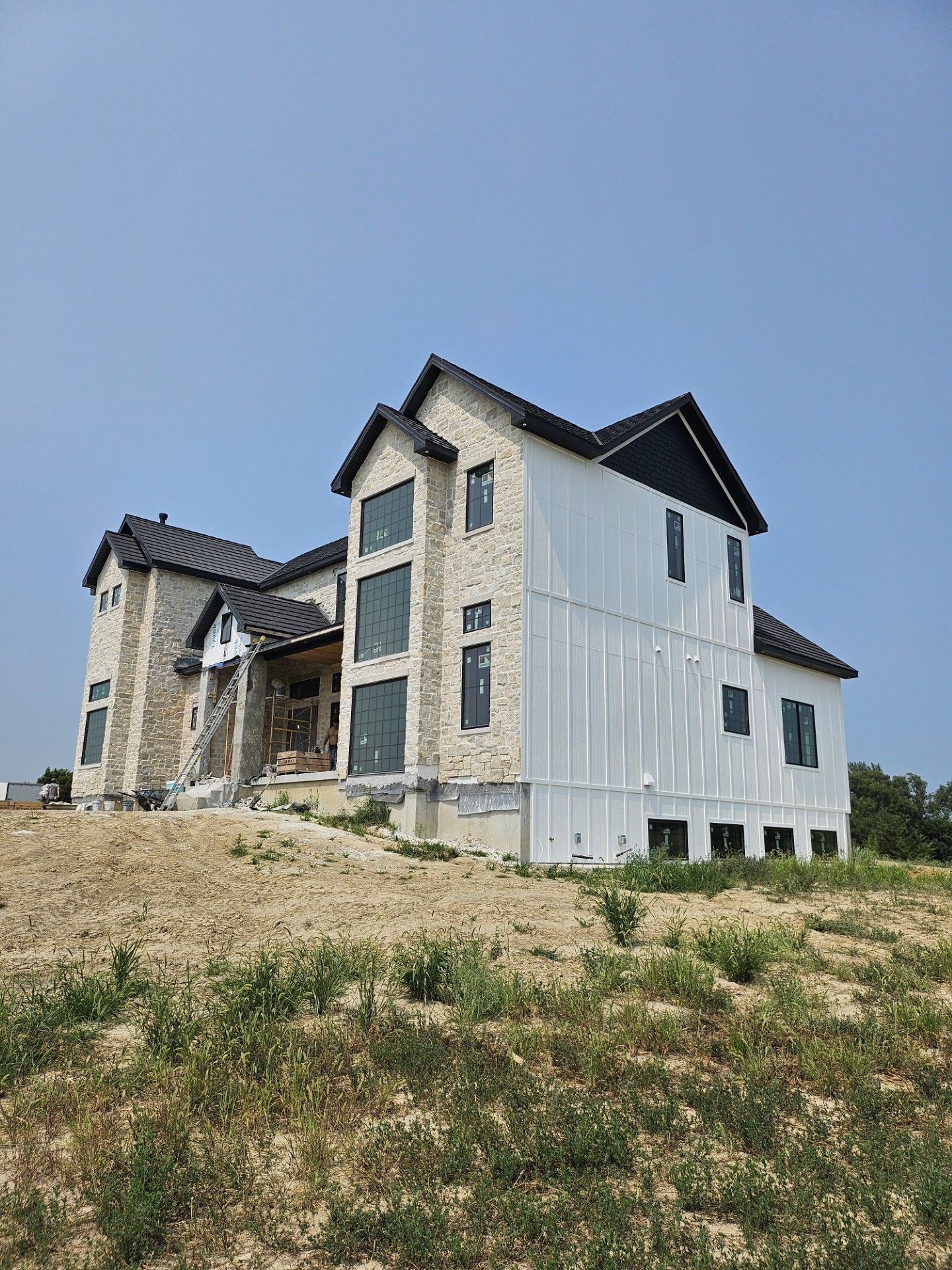 A large room with wooden walls and a bucket on the floor.