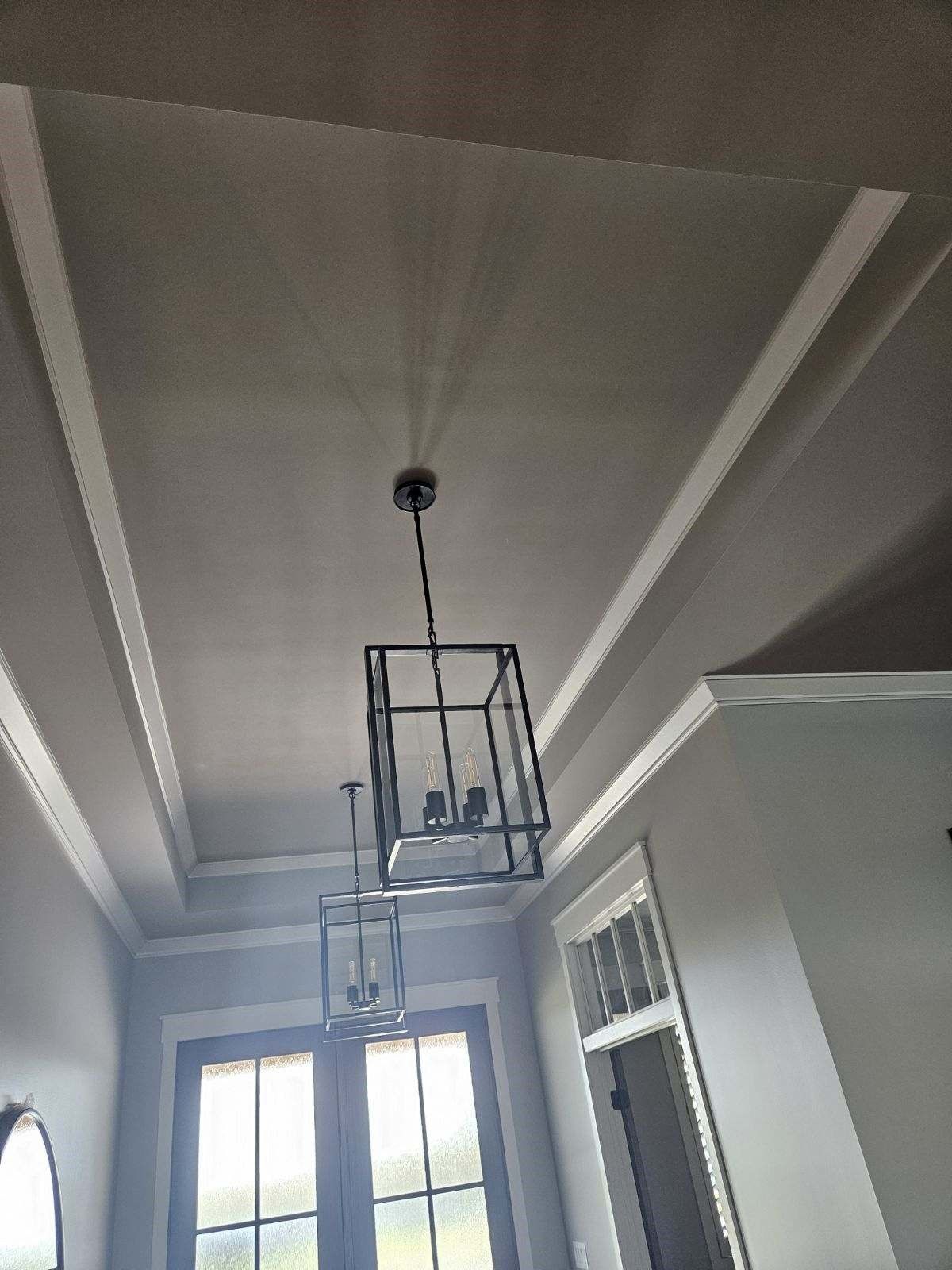 A chandelier is hanging from the ceiling of a room.