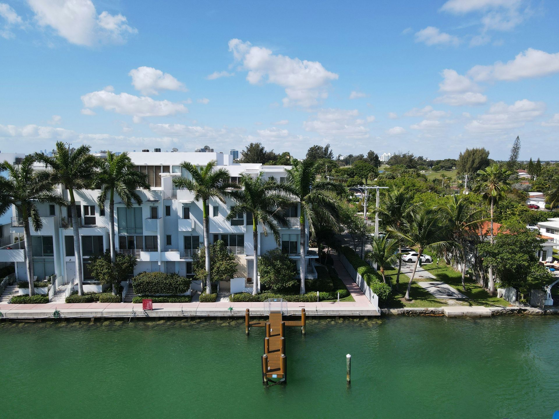 An aerial view of a building next to a body of water