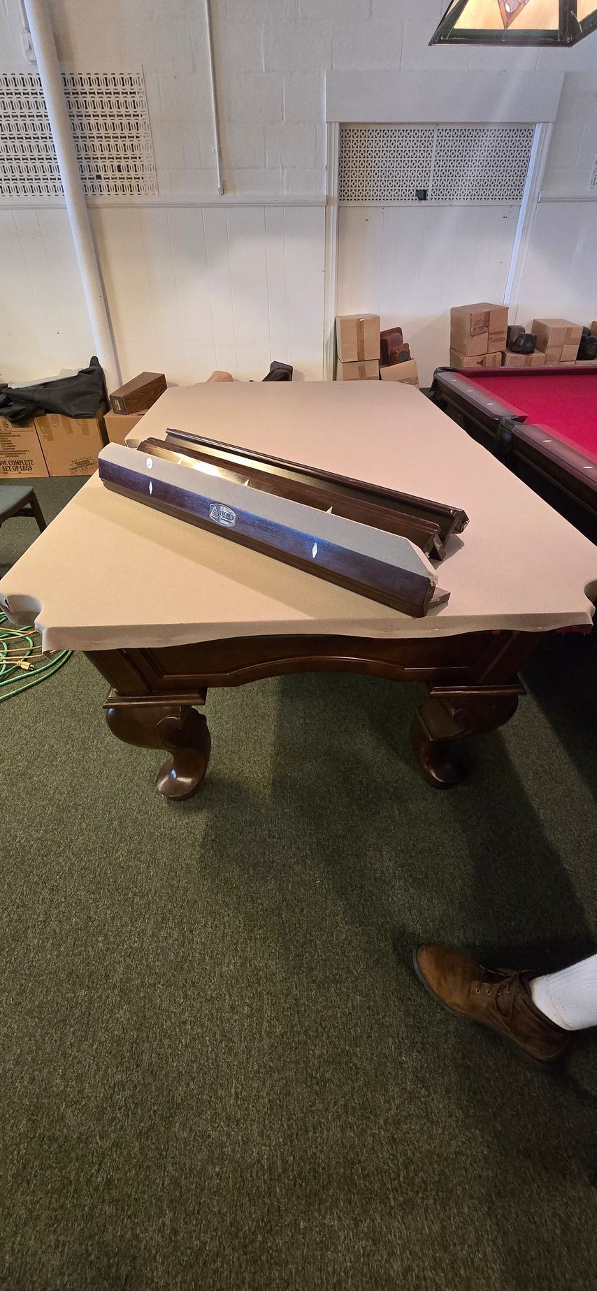 Two long metal blades resting diagonally on a table in a living room.