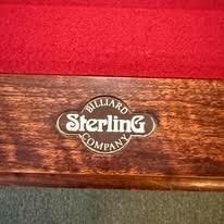Billiard Sterling Company logo on a wooden cue case with red fabric lining