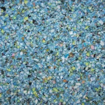 Close-up of mixed foam scraps in various colors, primarily blue and white.