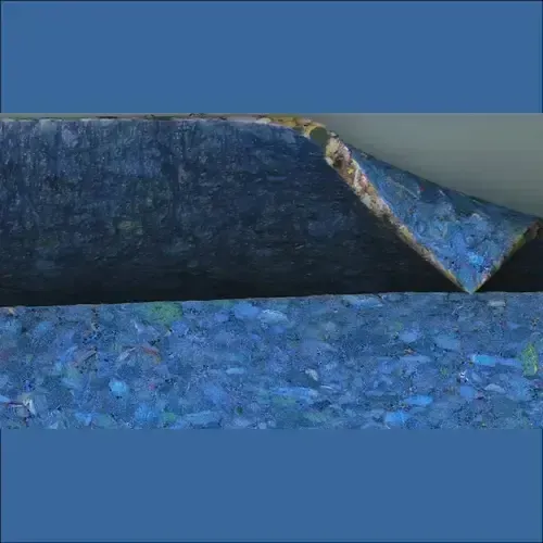 Blue recycled rubber mat, partially peeled back, revealing its layered construction.