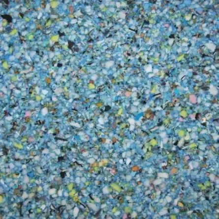 Close-up of mixed foam scraps in various colors, primarily blue and white.