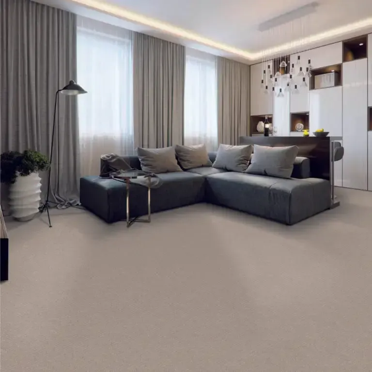 Modern living room with grey sectional sofa, neutral carpet, and large windows with grey curtains.