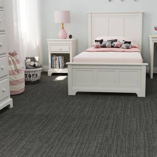 Bedroom with white furniture, pink accents, and gray carpet.