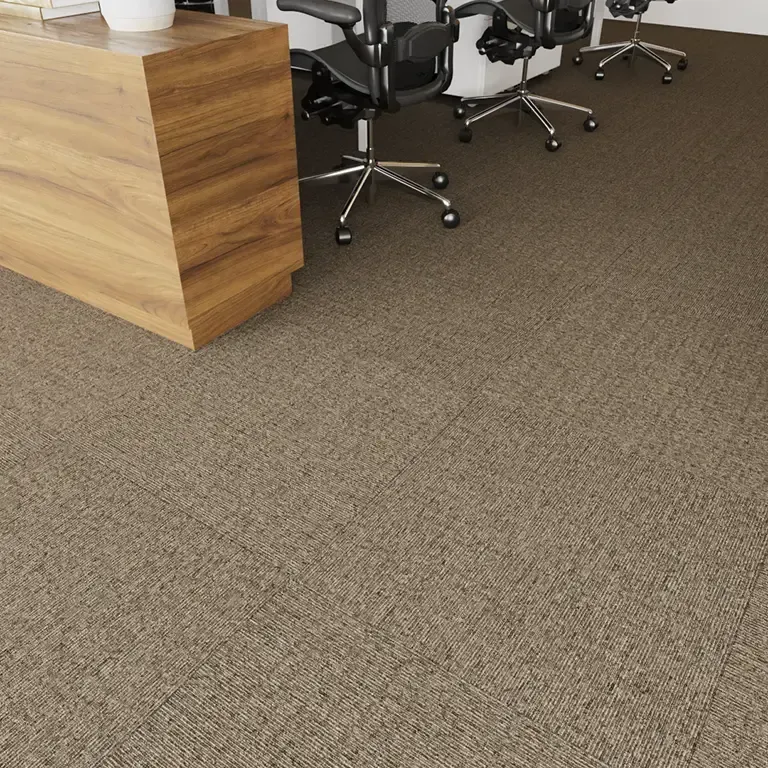 Office with brown carpet, wooden desk, and black chairs.