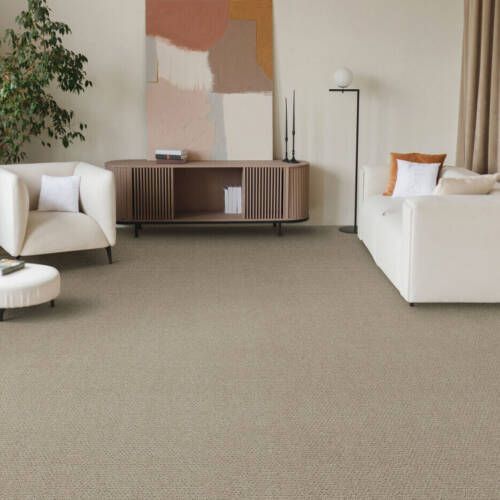 Living room with beige carpet, white furniture, and abstract art.