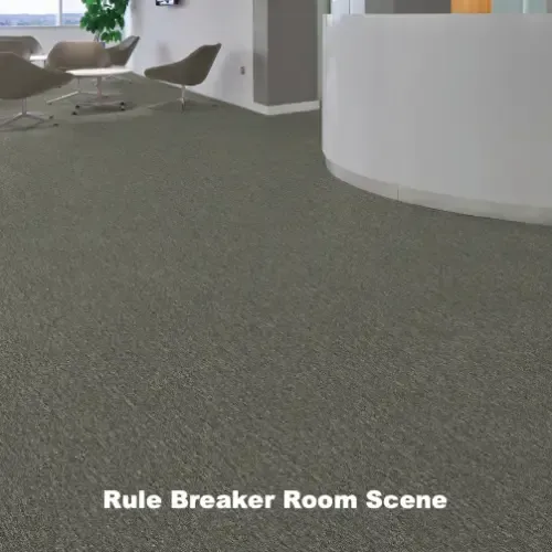 Gray carpeted room with seating area and reception desk; 