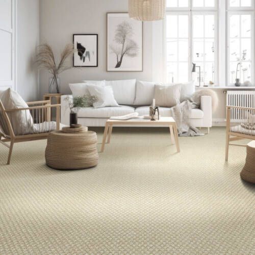 Living room with light beige carpet, white couch, light wood furniture, and artwork.