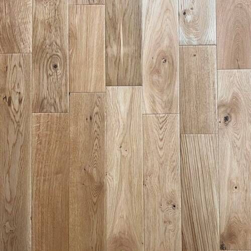 Close-up of hardwood flooring; light brown oak planks with wood grain visible.