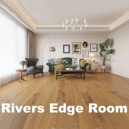 Rivers Edge Room: Interior view of a living room with wooden floors, sofa, armchair, and decorative elements.