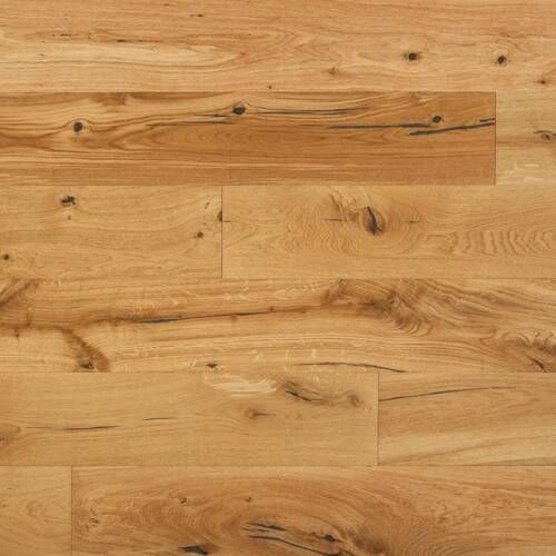 Light brown hardwood flooring with wood grain and knots.
