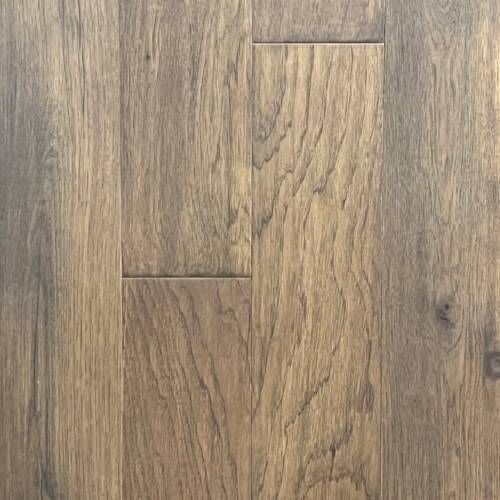 Close-up of wood flooring, showing vertical planks in shades of brown and gray with visible wood grain.