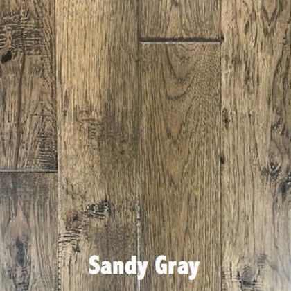 Sandy gray hardwood floor with wood grain and knots.